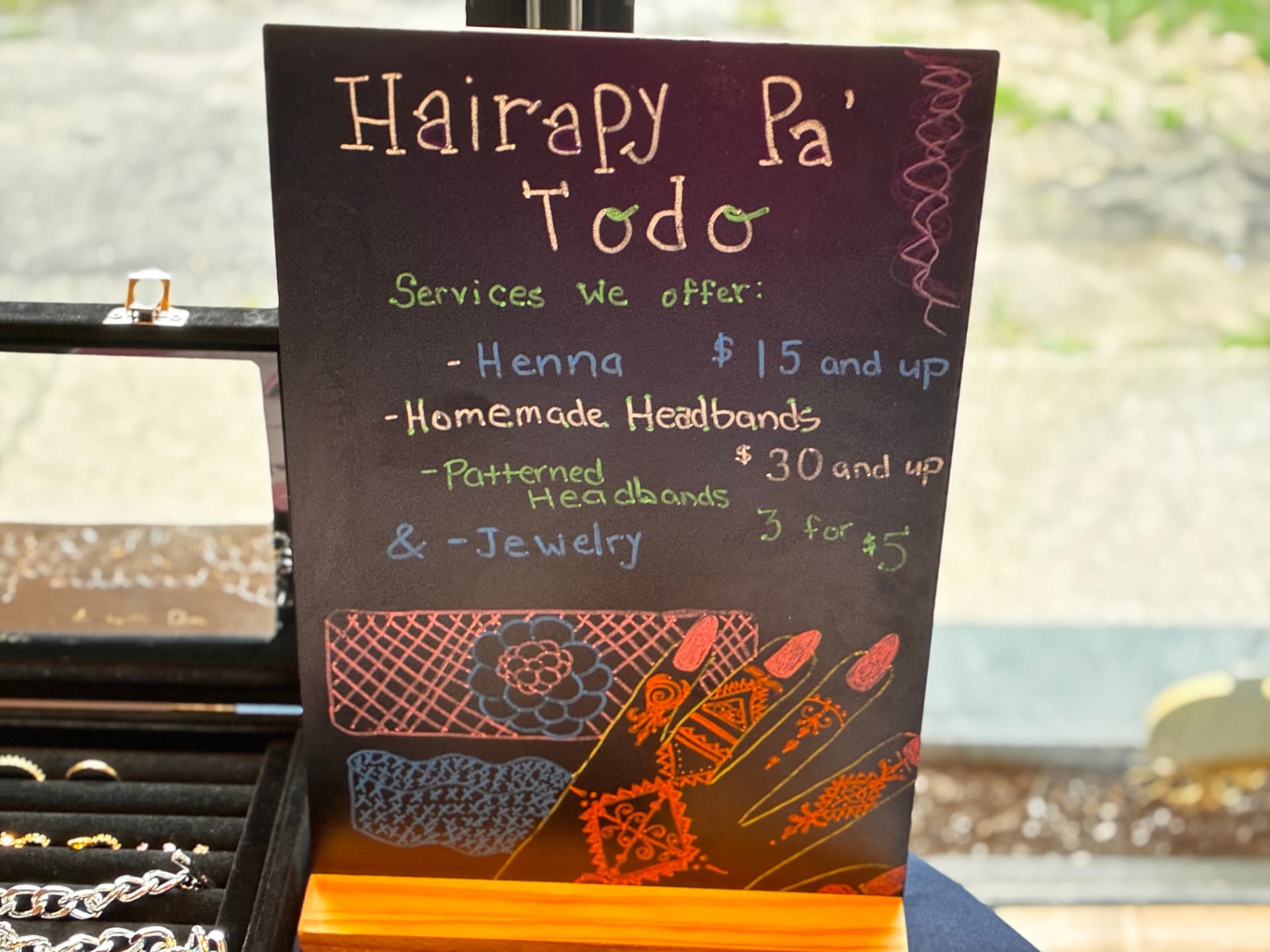 Hand-lettered Hairapy Pa Todo chalkboard services sign