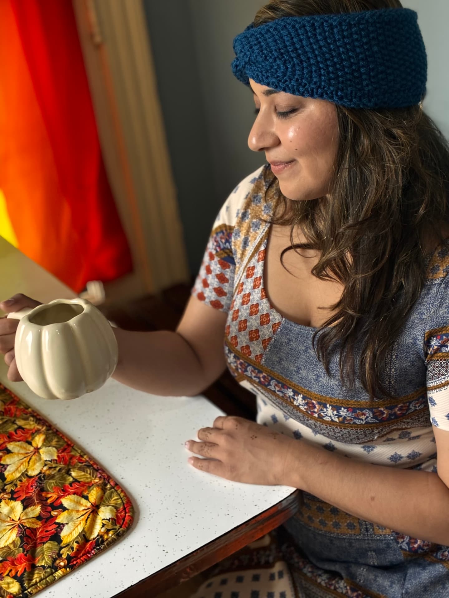 Knit headband worn at a cozy autumn tea table