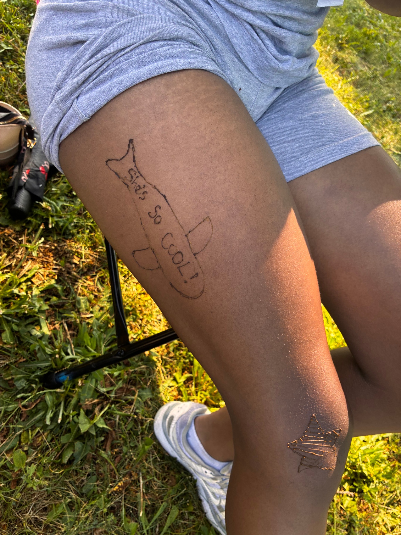 Playful 'she's so cool' airplane henna on the thigh