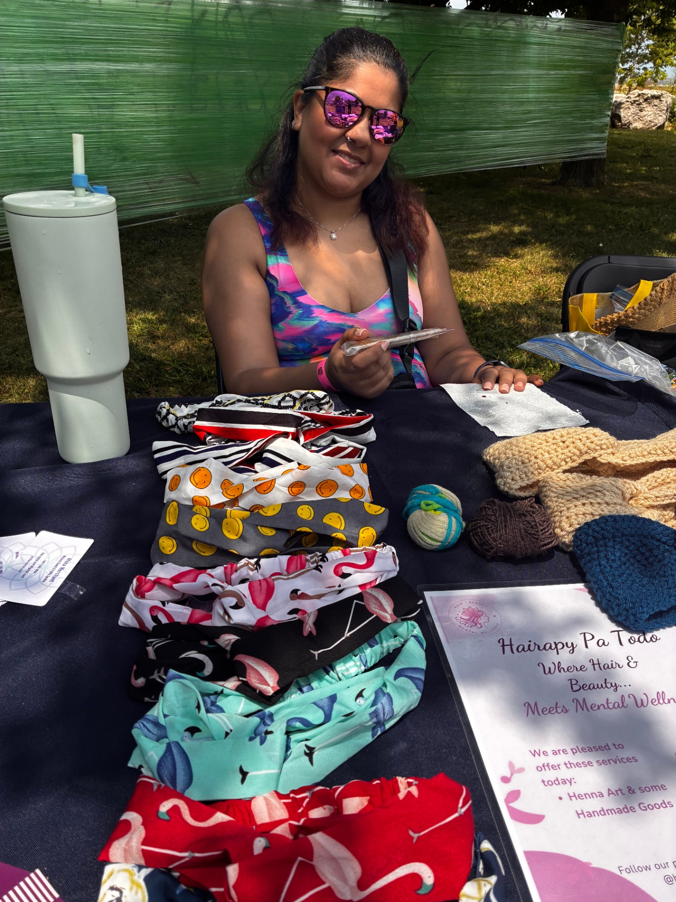 Hairapy Pa Todo pop-up booth with handmade goods and henna signage